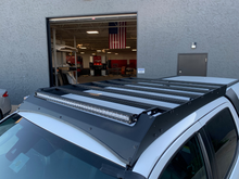 Load image into Gallery viewer, Top view of Economy Roof Rack on a white Toyota Tacoma - Cali Raised LED